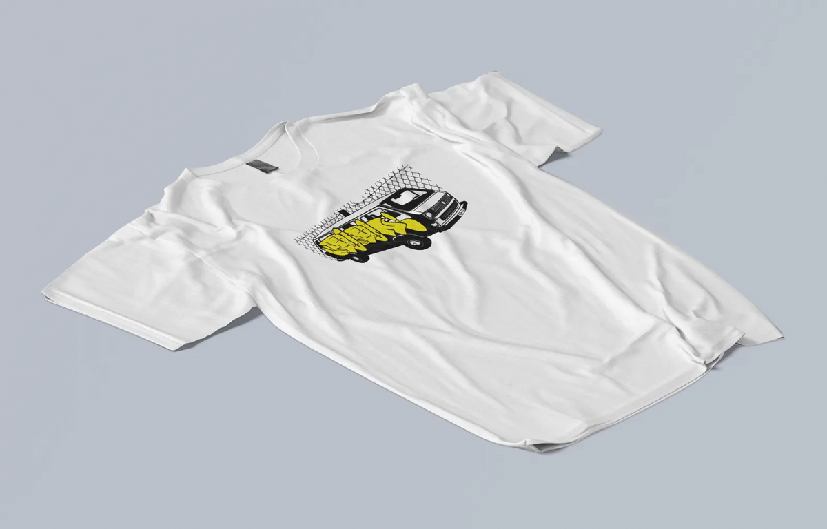 Yellow Van Tee laid flat at an angle, van graphic on the chest